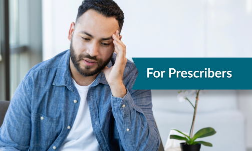 Man looking frustrated with head in hand