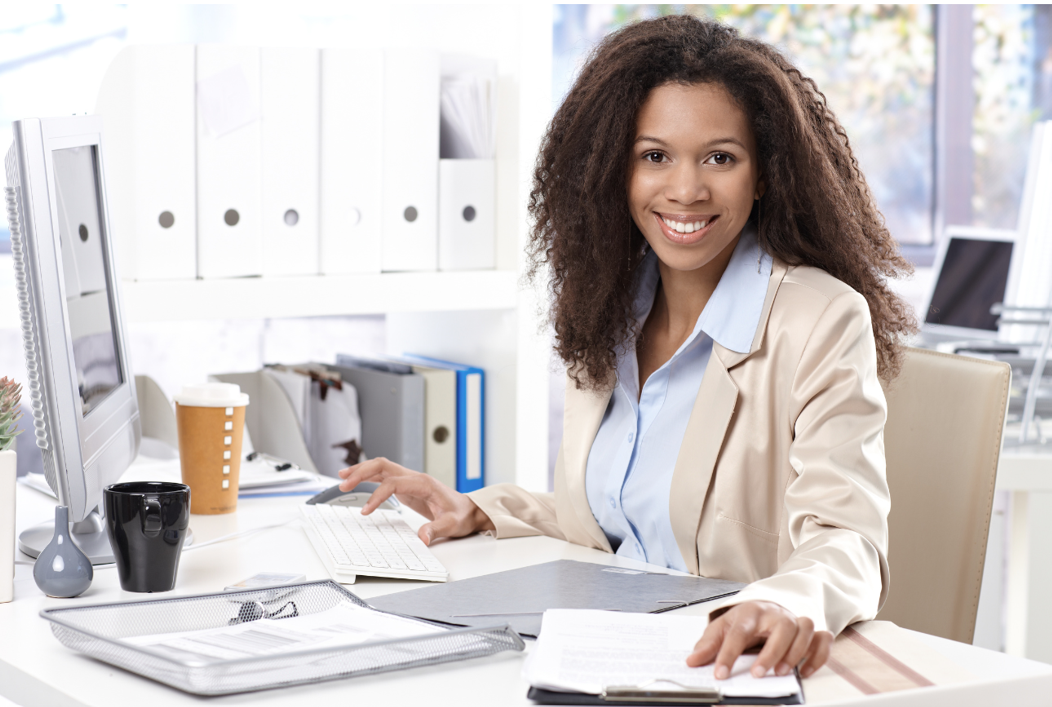 woman sitting at a desk smiling