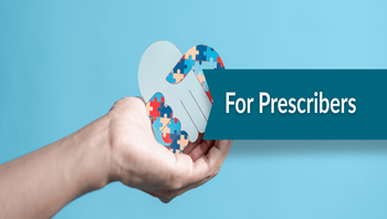 Hand holding a heart made of multicolor puzzle pieces